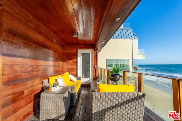 a view of a patio with table and chairs with wooden floor