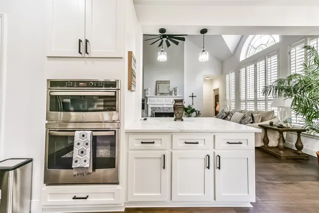 a kitchen that has a sink a stove a table and chair