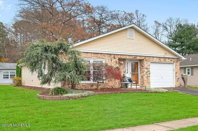 a front view of house with a garden