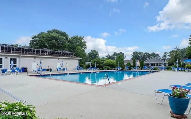 a view of a house with pool and sitting area