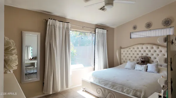 a bedroom with a bed and a window