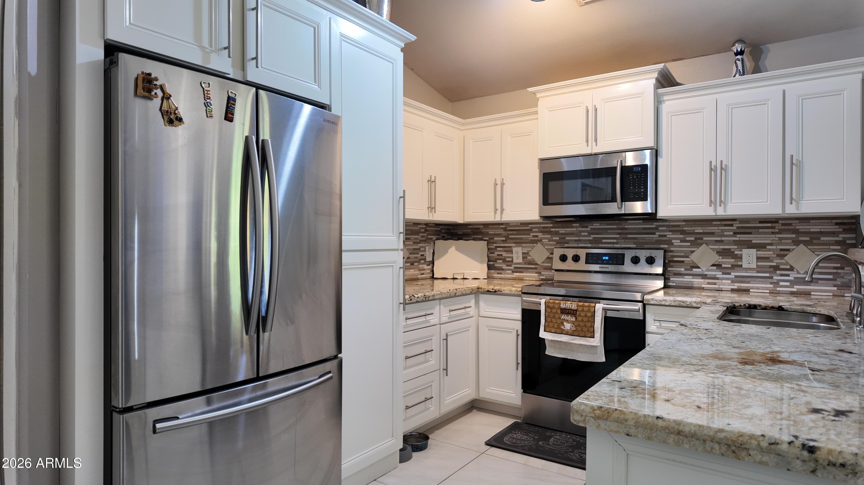 8429 West Granada Road Phoenix, AZ 85037 - Photo 8 of 12 a kitchen with cabinets stainless steel appliances and a counter space