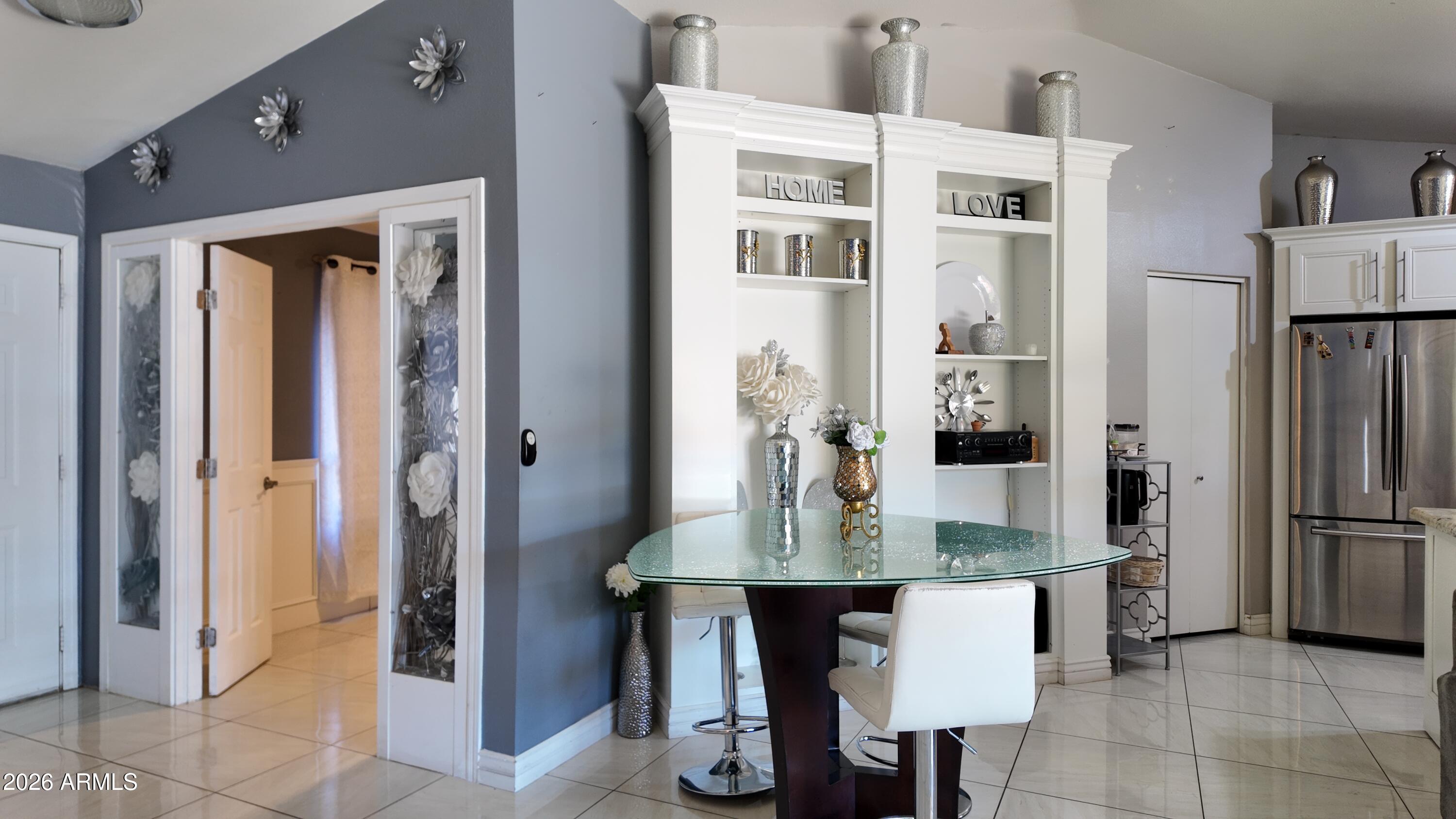 8429 West Granada Road Phoenix, AZ 85037 - Photo 9 of 12 a kitchen with refrigerator and table