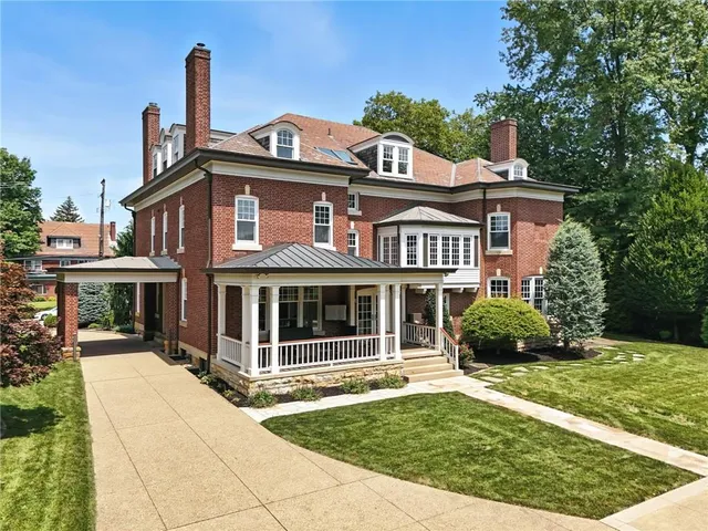 a front view of a house with a garden