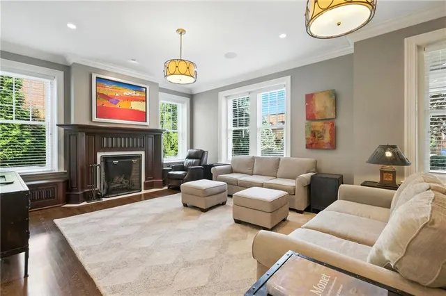 a living room with furniture a fireplace and a large window