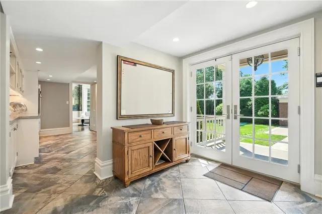 a large kitchen with kitchen island granite countertop a large window and a counter top space