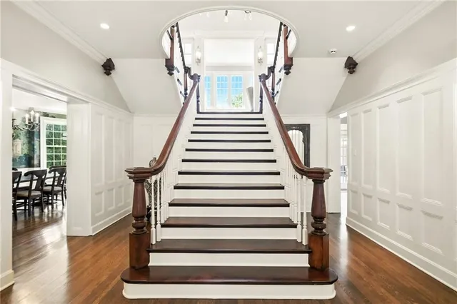 a view of entryway and hall with wooden floor