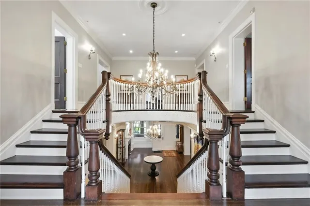 a view of entryway and hall with wooden floor