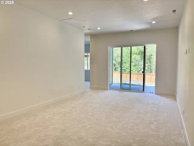 a view of an empty room with a balcony