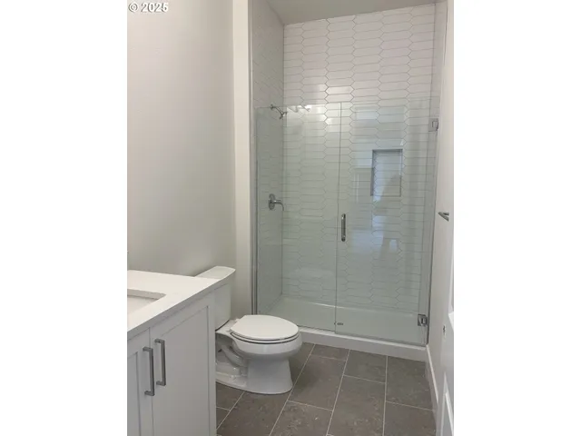 a bathroom with a shower and a toilet