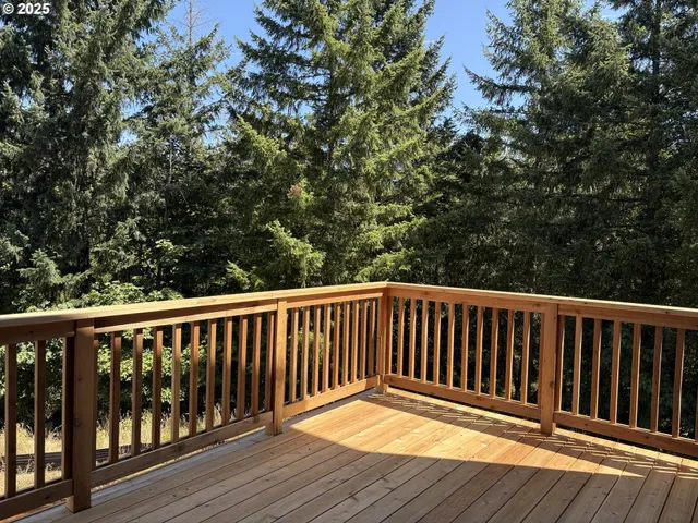 a balcony with wooden floor and wooden fence