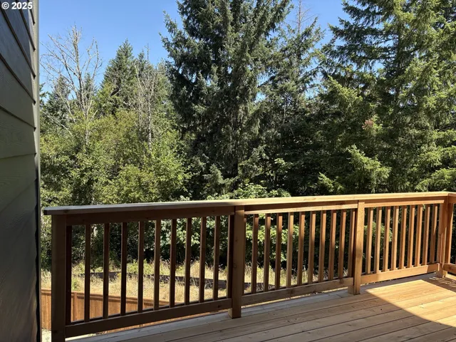 a balcony with wooden floor and fence