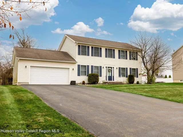 a view of a house with a yard and garage
