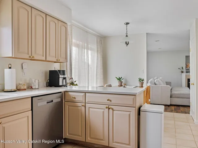 a kitchen with white cabinets and sink
