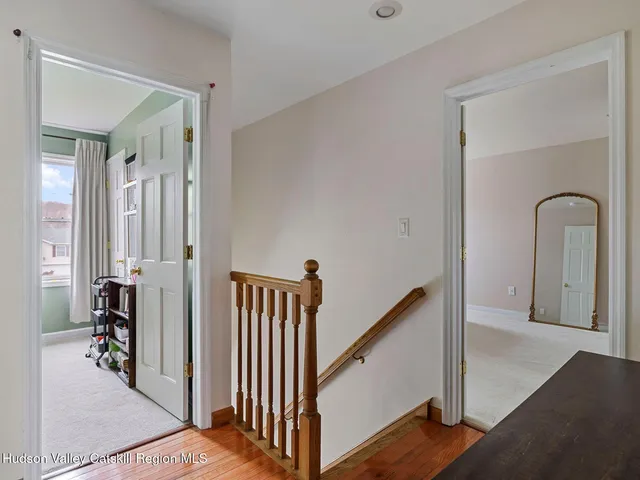 a view of a hallway with windows and stairs