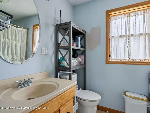 a bathroom with a sink a toilet and a mirror