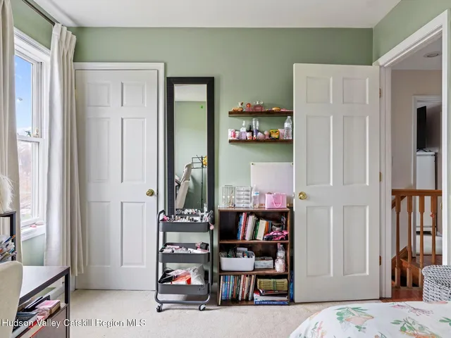 a bedroom with furniture and a book shelf