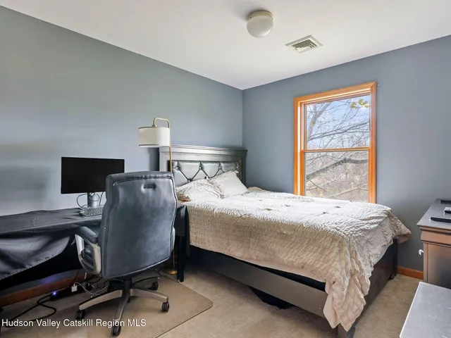 a bedroom with a bed a desk and chair