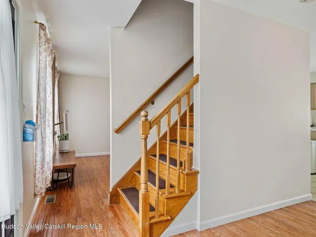 a view of an entryway with wooden floor and a livingroom