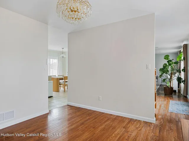 a view of an empty room and wooden floor