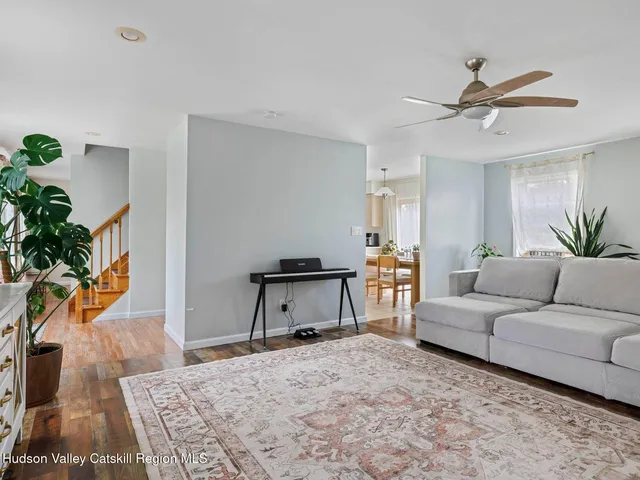a living room with furniture and a potted plant