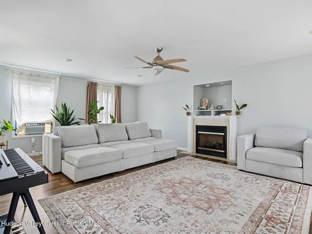 a living room with furniture a fireplace and a chandelier