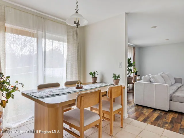 a view of a dining room with furniture and window