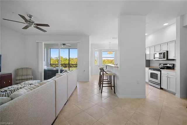 a kitchen with white cabinets a sink and stainless steel appliances