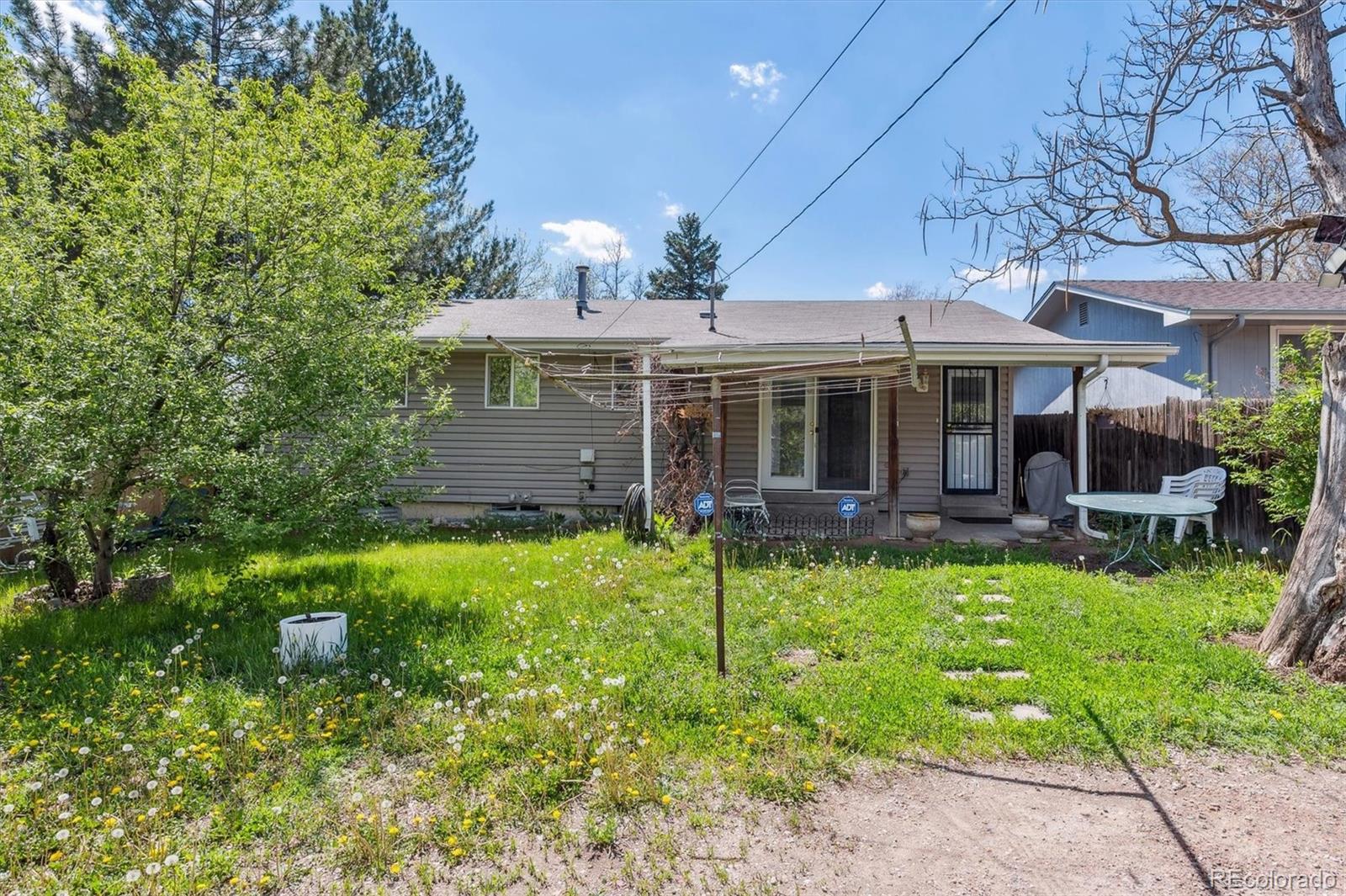200 Perry Street Denver, CO 80219 - Photo 12 of 24 a view of a house with a yard and potted plants