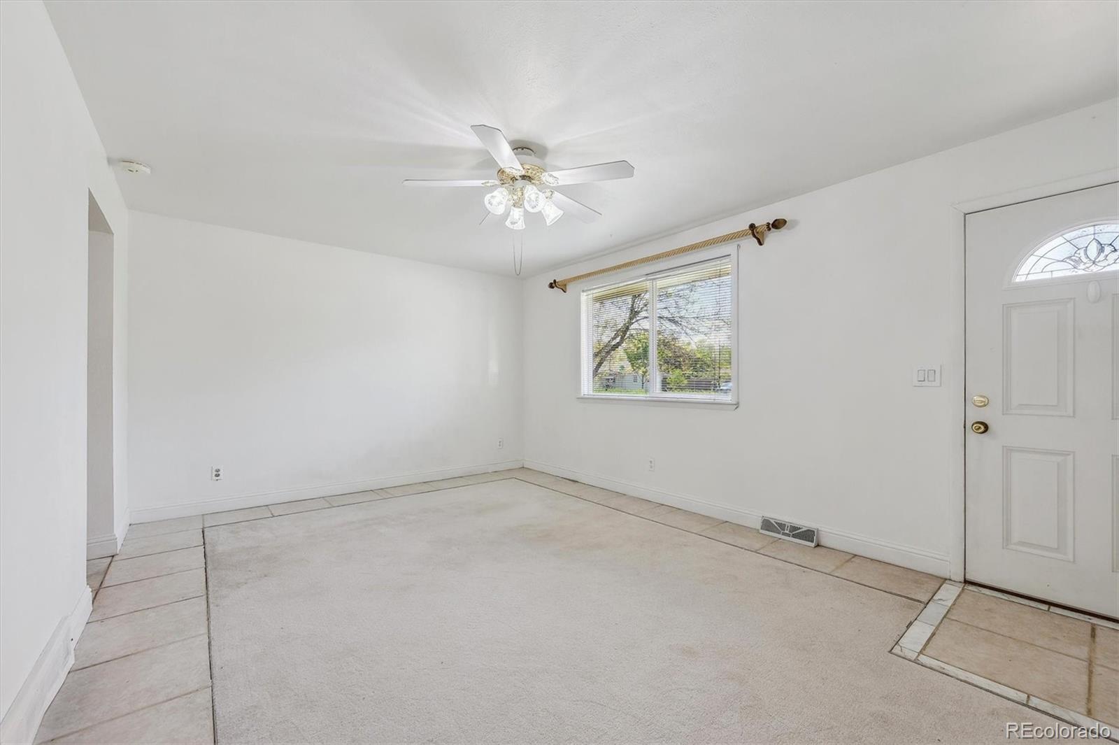 200 Perry Street Denver, CO 80219 - Photo 13 of 24 a view of an empty room with a fan