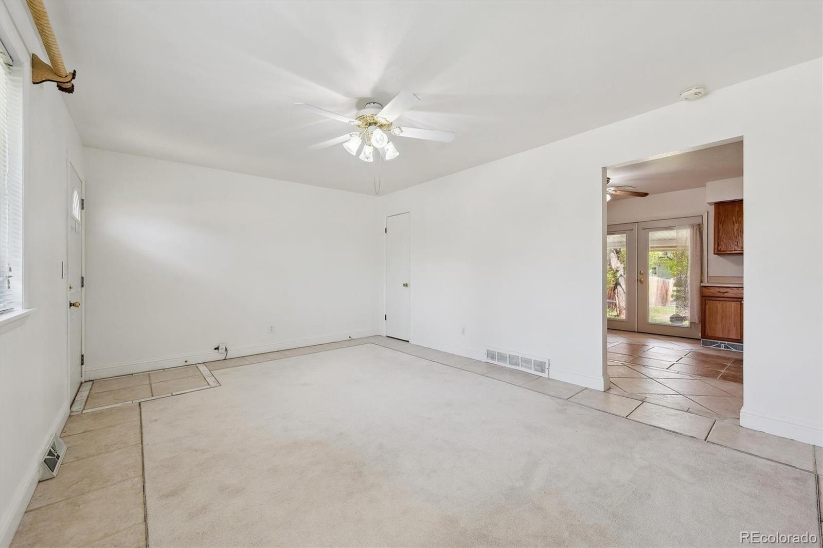 200 Perry Street Denver, CO 80219 - Photo 14 of 24 an empty room with fan and entrance