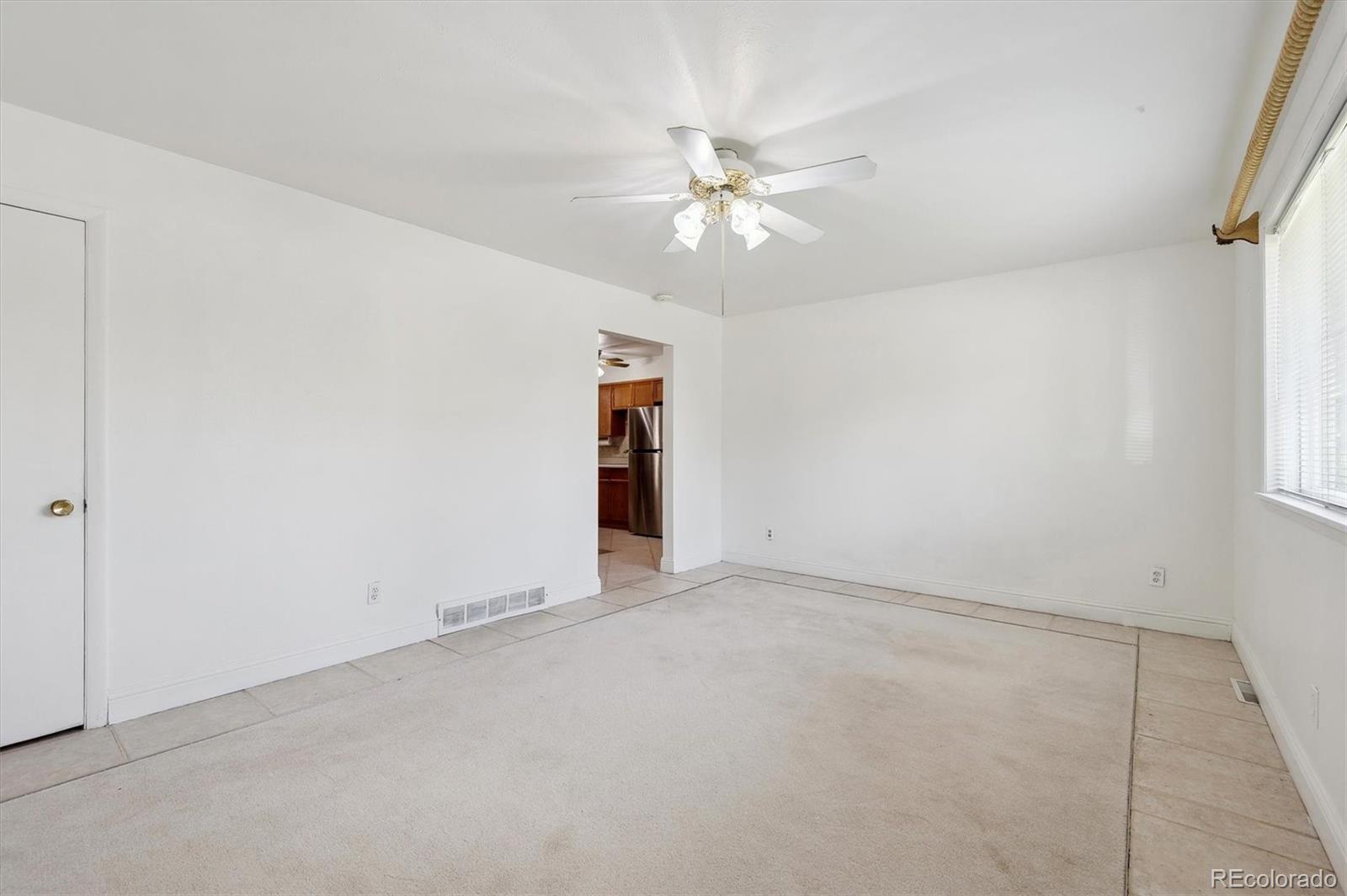 200 Perry Street Denver, CO 80219 - Photo 15 of 24 an empty room with an entryway and fan