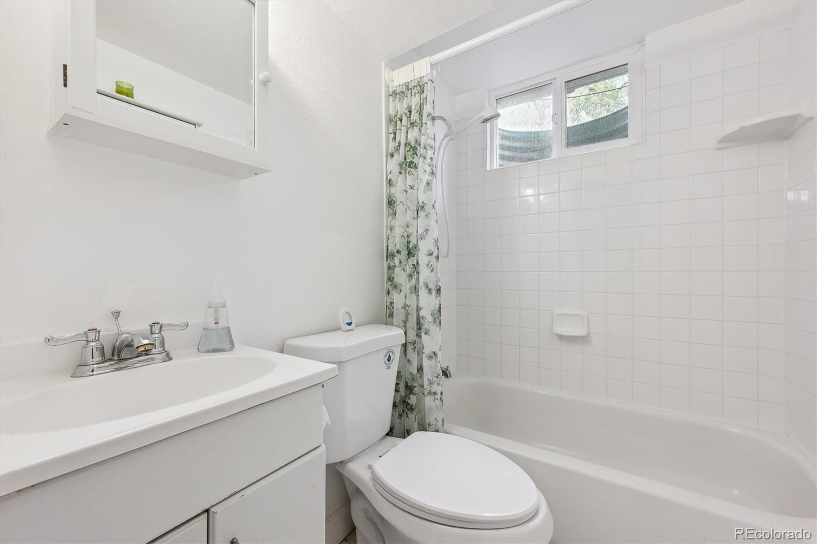 200 Perry Street Denver, CO 80219 - Photo 23 of 24 a bathroom with a sink a toilet and shower