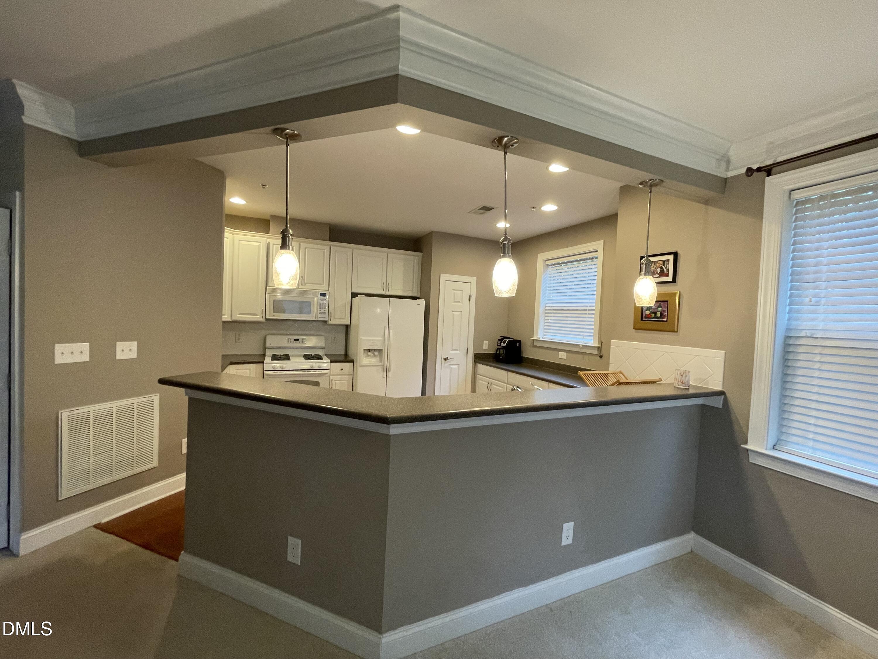 10411 Rosegate Court, Unit 3 Raleigh, NC 27617 - Photo 12 of 62 a kitchen with stainless steel appliances a sink stove and cabinets