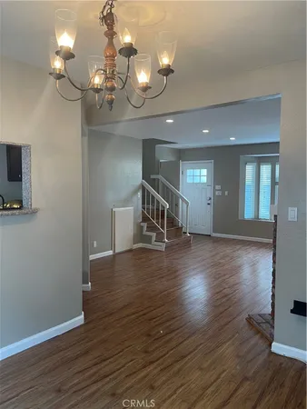 a view of livingroom and kitchen with wooden floor