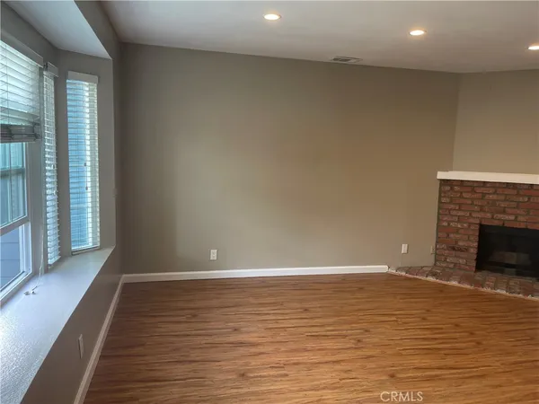 wooden floor in an empty room with a fireplace