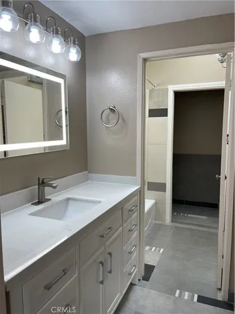 a bathroom with a sink double vanity and a mirror