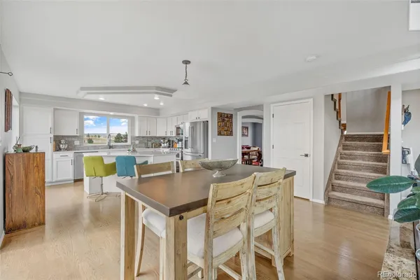 a view of a dining room with furniture and wooden floor