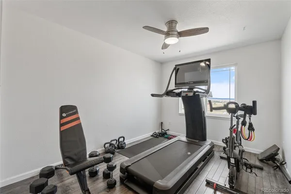 a room with gym equipment and mirror