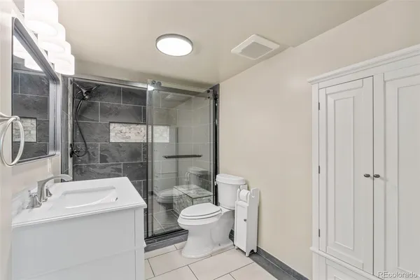a bathroom with a toilet sink and shower