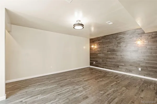 a view of an empty room with wooden floor