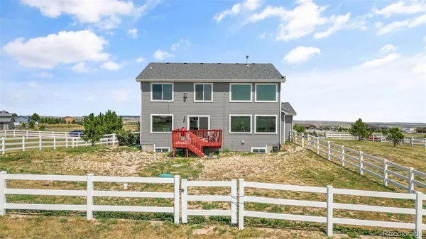 a view of a house with wooden fence