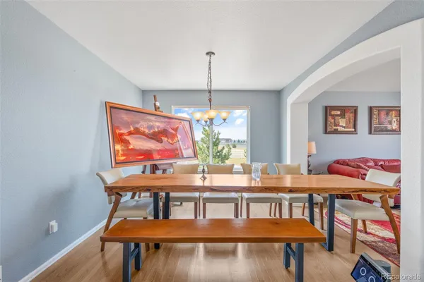 a dining room with furniture a rug and wooden floor