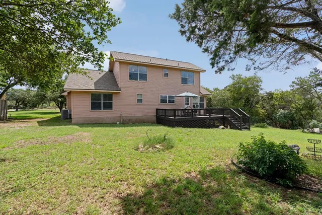 a view of a house with a yard and sitting area