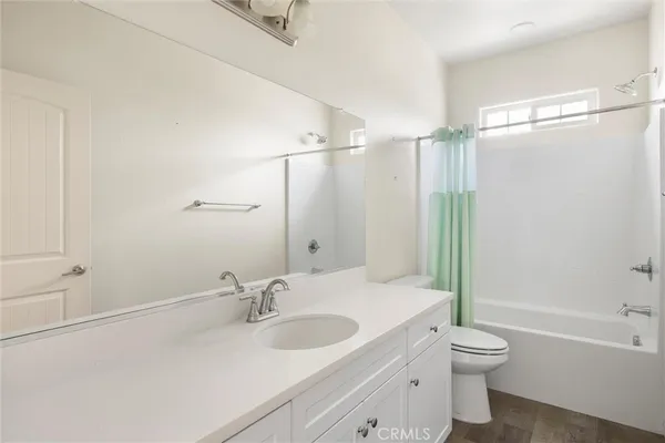 an empty room with a window and a ceiling fan