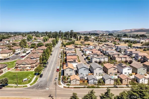 an aerial view of residential houses with city view