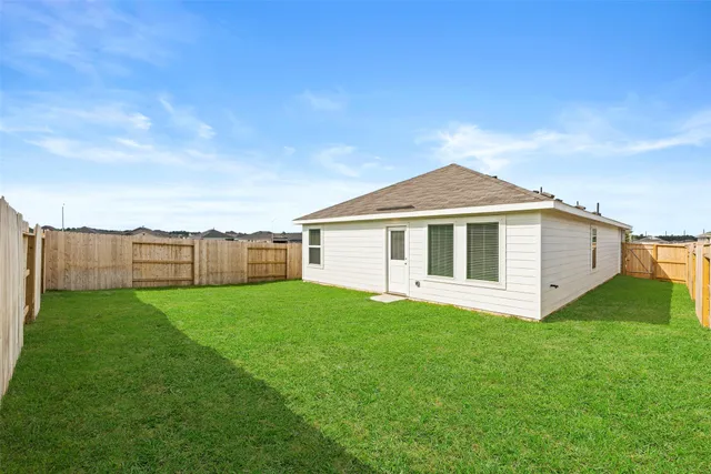 a view of a yard in front of a house with garage
