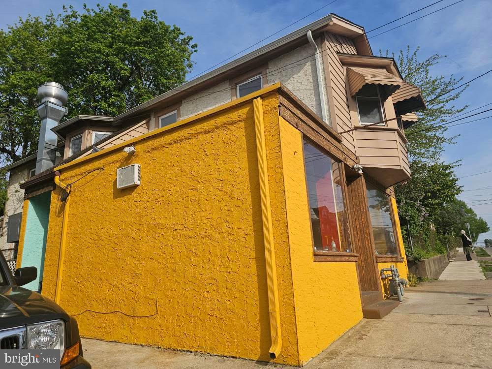 107 East County Line Road, Unit 2 Ardmore, PA 19003 - Photo 12 of 17 a view of a house with a door and wooden bench