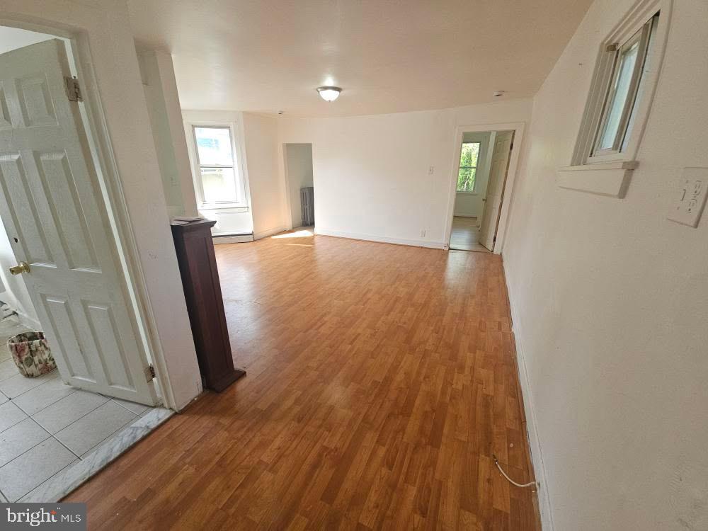 107 East County Line Road, Unit 2 Ardmore, PA 19003 - Photo 2 of 17 a view of a room with wooden floor and staircase