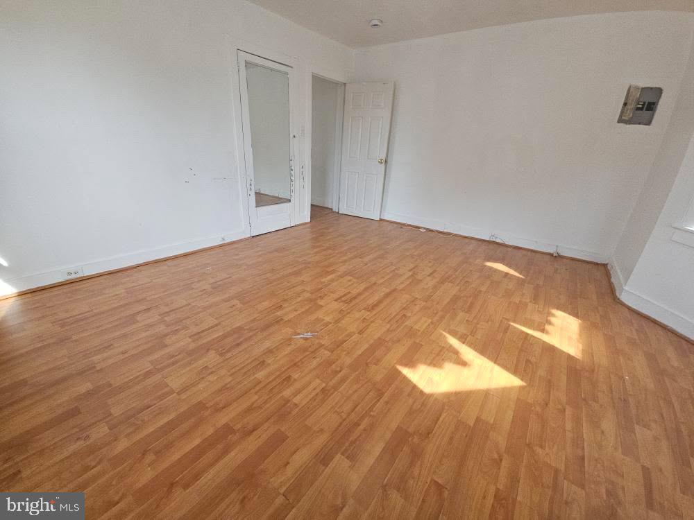 107 East County Line Road, Unit 2 Ardmore, PA 19003 - Photo 5 of 17 an empty room with wooden floor and windows